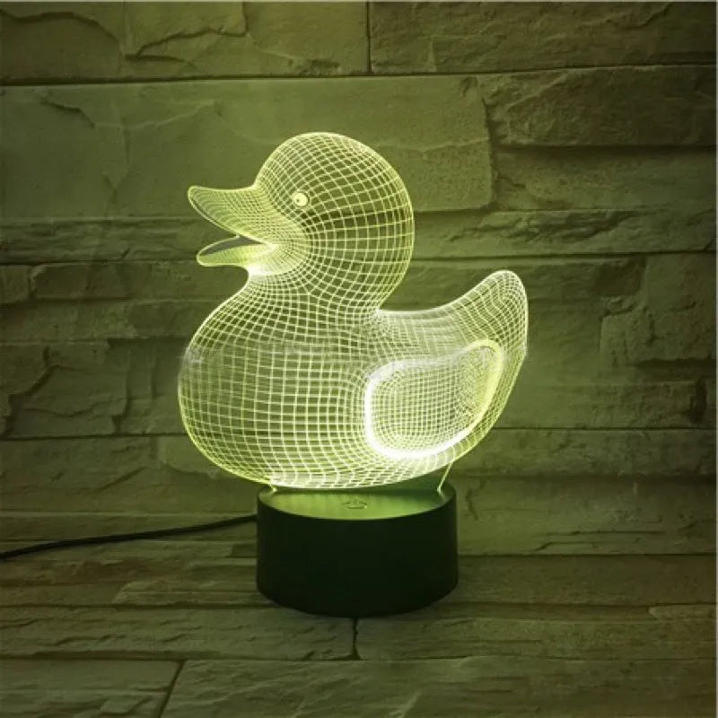 Little yellow duck 3D night light with colour-changing LED display on an ABS base, showing remote control.