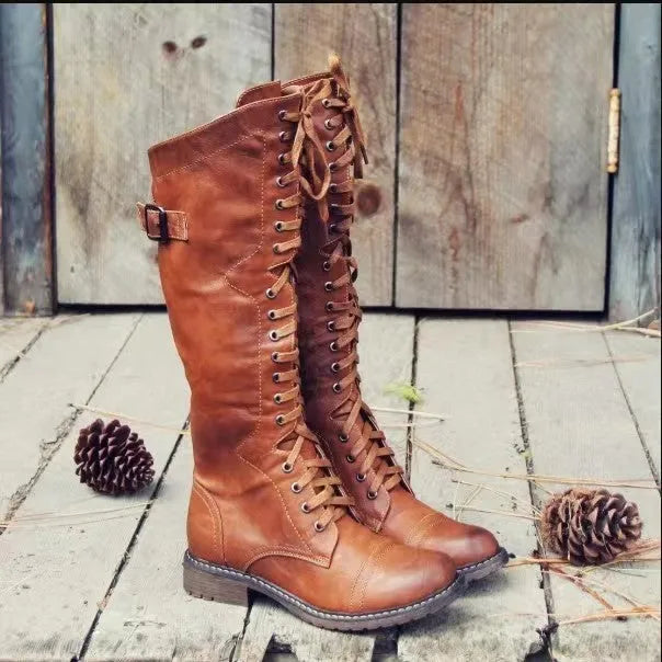 Women's black chunky heel high leg boot with a round toe and rubber sole.