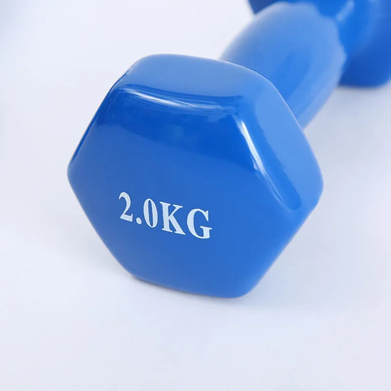 Bright plastic coated fitness dumbbells in various weights for home gym yoga and aerobics