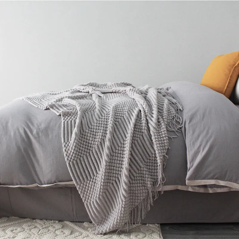 Small light grey polyester nap blanket laid flat showing 127x170cm size.