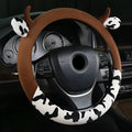 Short plush car steering wheel cover in black colour showing 38cm diameter measurement