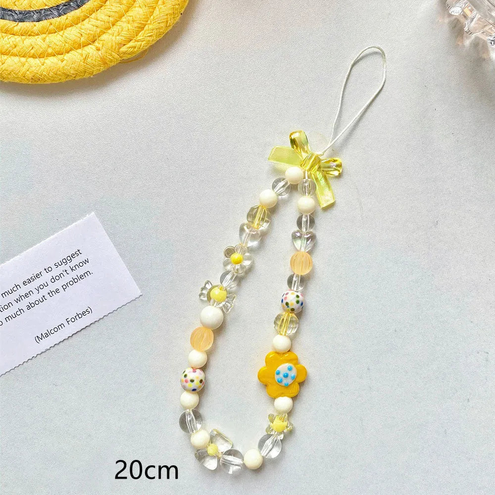 Beaded flower mobile phone lanyard with adjustable sliding bead in blue, pink, and yellow colour options