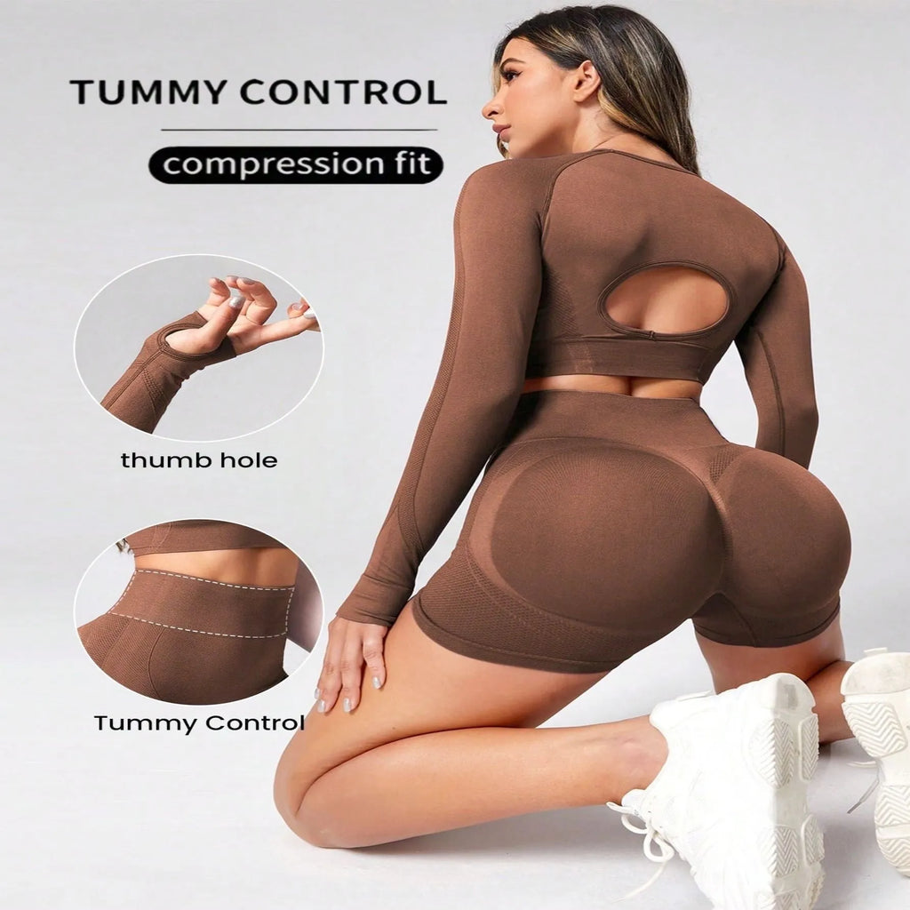 Women's black yoga suit set with long sleeve top and high-waist tight leggings laid flat.