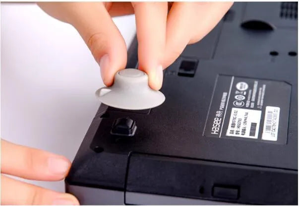 Grey plastic laptop cooling pad stand with four pieces for temperature reduction and ergonomic typing