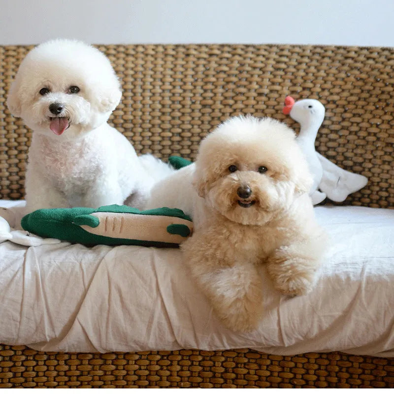 Green plush stuffed toy dog on a white background.