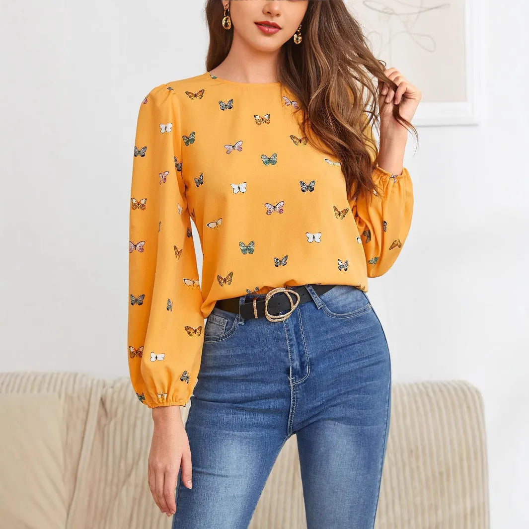 Green women's long sleeve shirt with butterfly print, showing loose fit and button front.