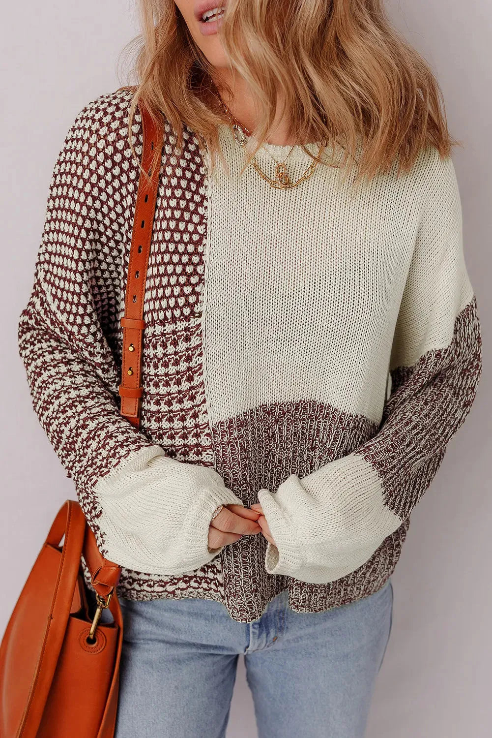 Dark khaki loose sweater with colour block design and back tie, on a model.