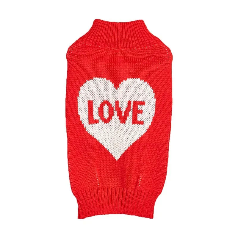 Red knitted dog jumper with a white love heart and bow design on a small dog