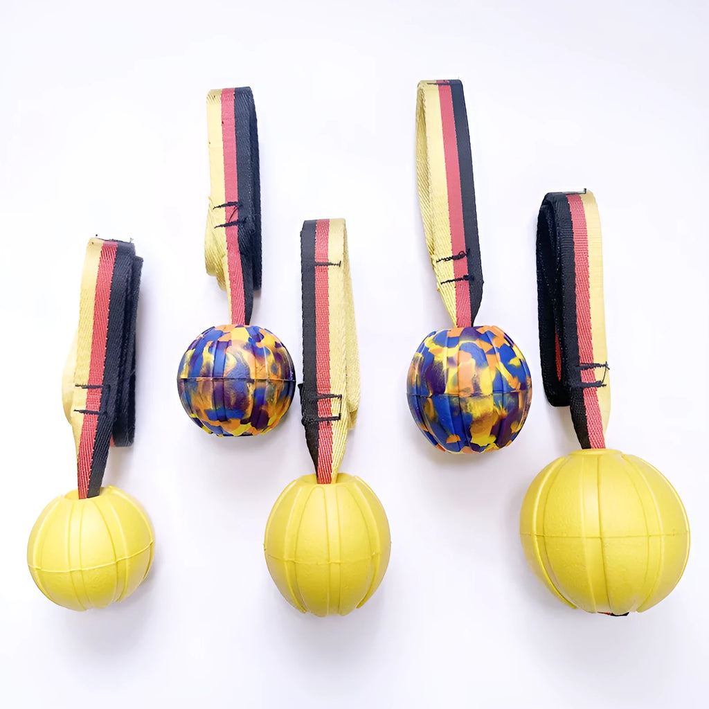 Yellow and camouflage coloured EVA floating knot balls for dogs in three different sizes on a blue background.