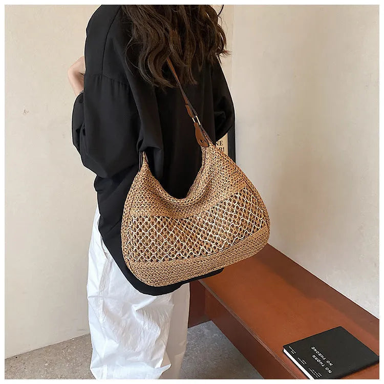 Women's khaki straw cross body bag with a square shape and outer pocket.