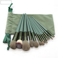 13 piece green makeup brush set with man-made fibre bristles and plastic handles