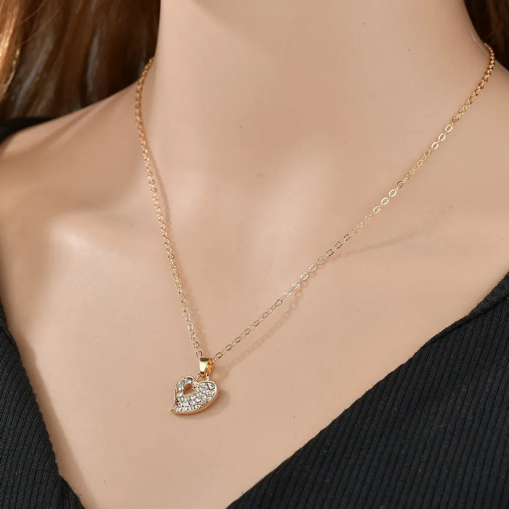 Gold alloy jewellery set with love heart, water drop, and bell pendants including earrings, necklace, and bracelet