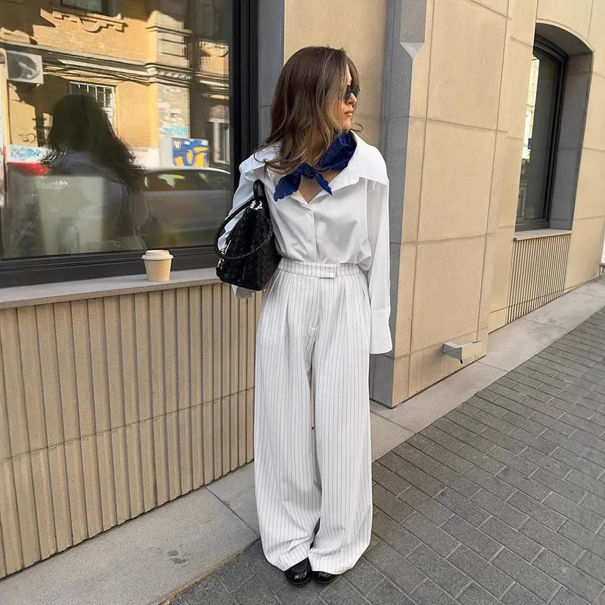 White striped wide-leg casual trousers with zipper detailing on a mannequin.