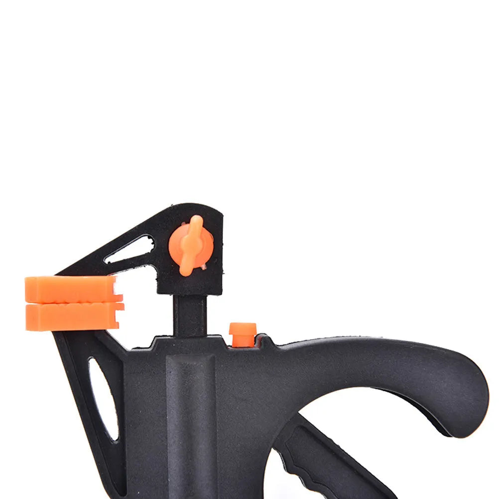 Black woodworking F clip 4 inch with plastic body and carbon steel rod on wooden board