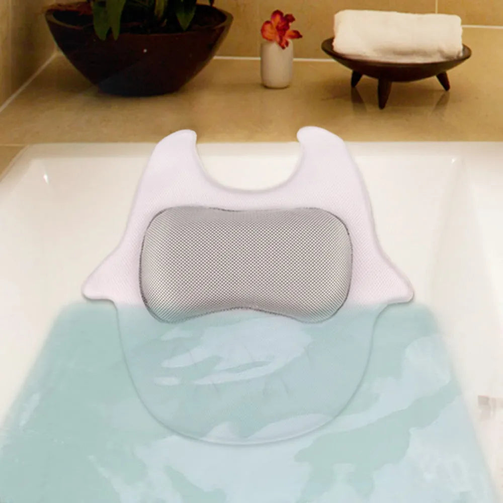 White ergonomic bathtub pillow with owl shape, 5D mesh fabric, and strong suction cups on a smooth bath surface