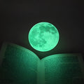 30cm green fluorescent moon wall sticker with super bright glitter finish on a bedroom wall