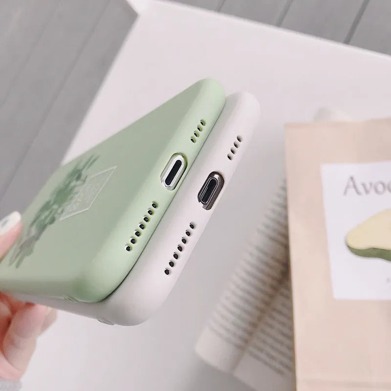 White silicone iPhone case with detailed green painted plant leaves design on the back.