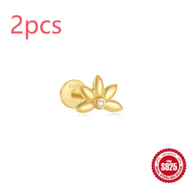 A gold tone sterling silver ear stud featuring a dangling tassel and XINGX inlaid design on the stud.