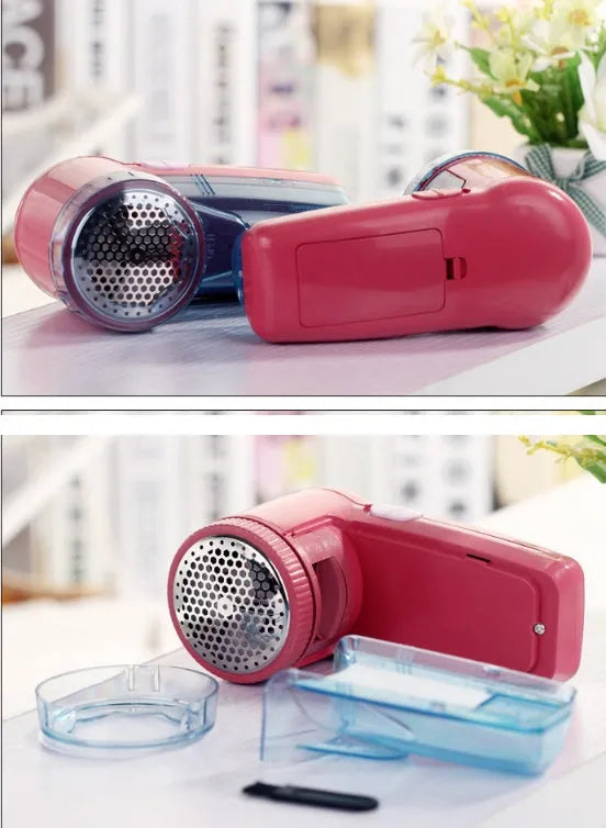 White portable electric lint remover for clothing on a table.