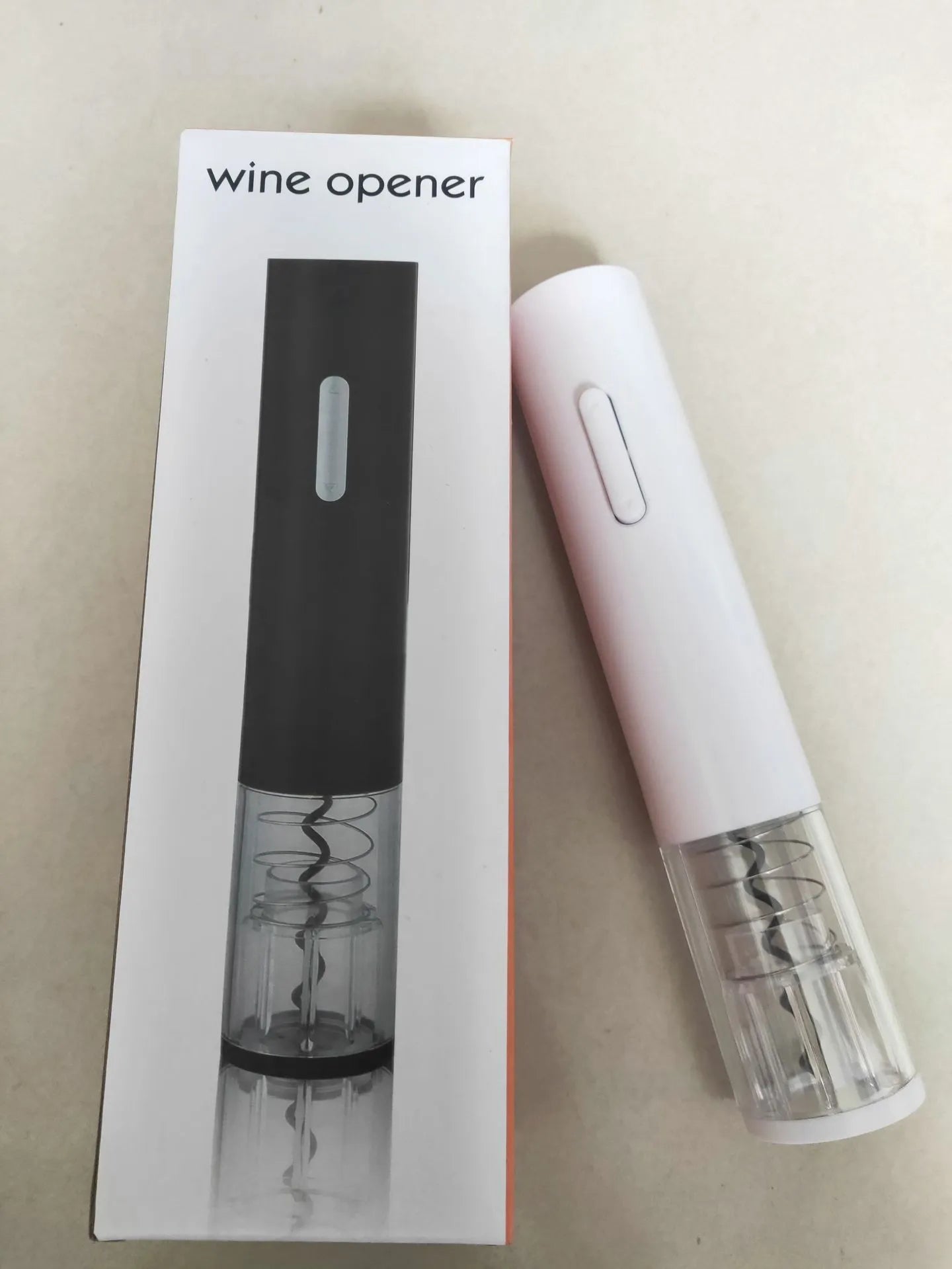 Black electric wine bottle opener with automatic corkscrew and foil cutter on a kitchen counter