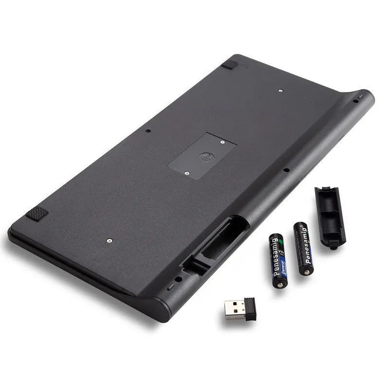 Black and white wireless keyboard and mouse set on a wooden desk.