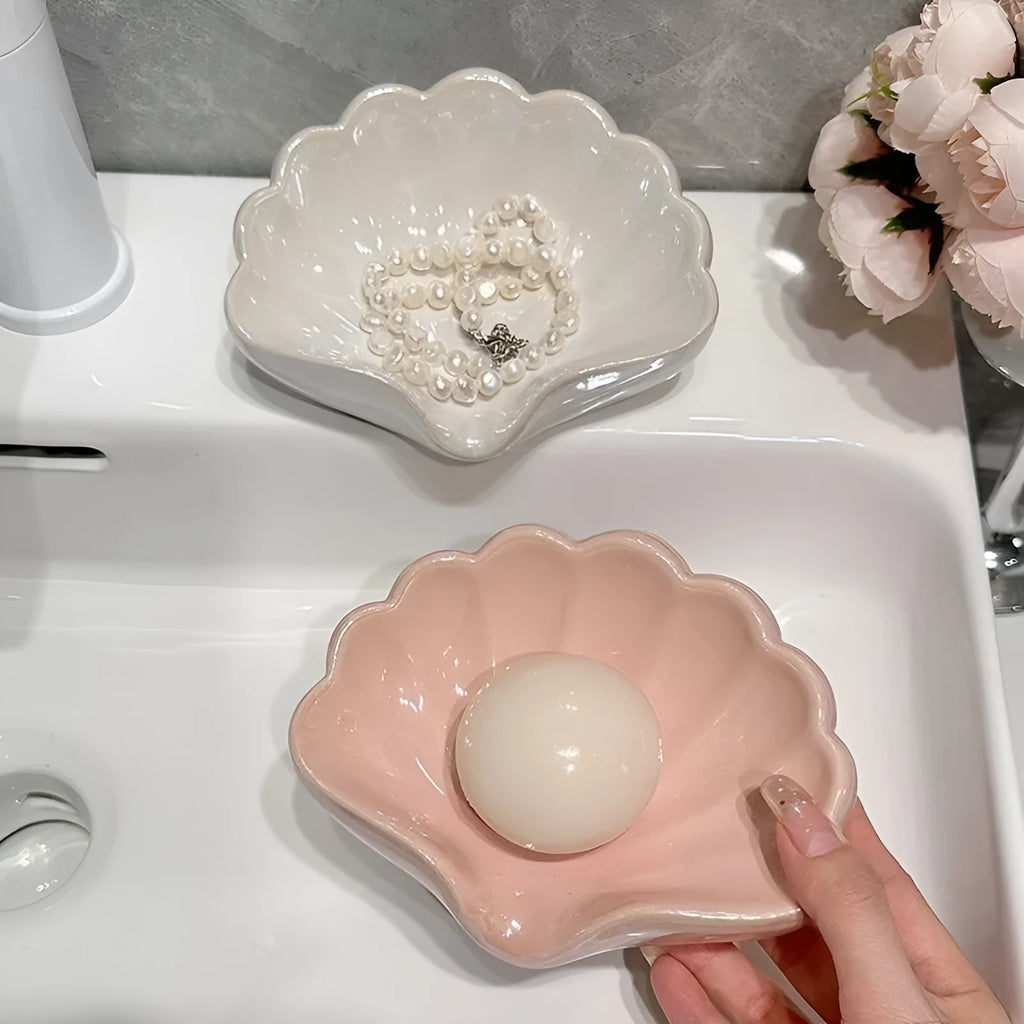 Plastic shell-shaped soap dish in pearl white colour for bathroom use