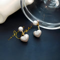 Pair of women's heart-shaped alloy stud earrings with artificial gemstone inlay, Korean style.