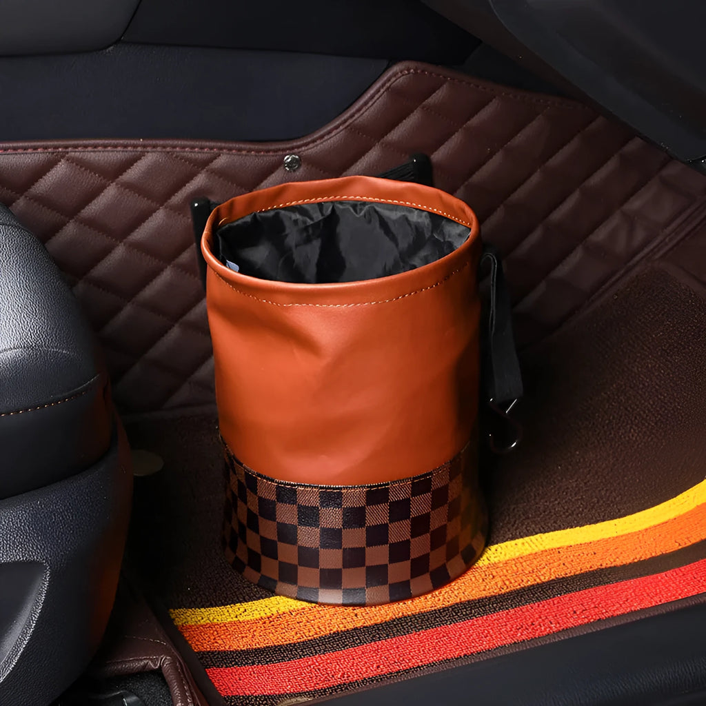 Brown retractable leather trash can for car interior use, shown with handle.