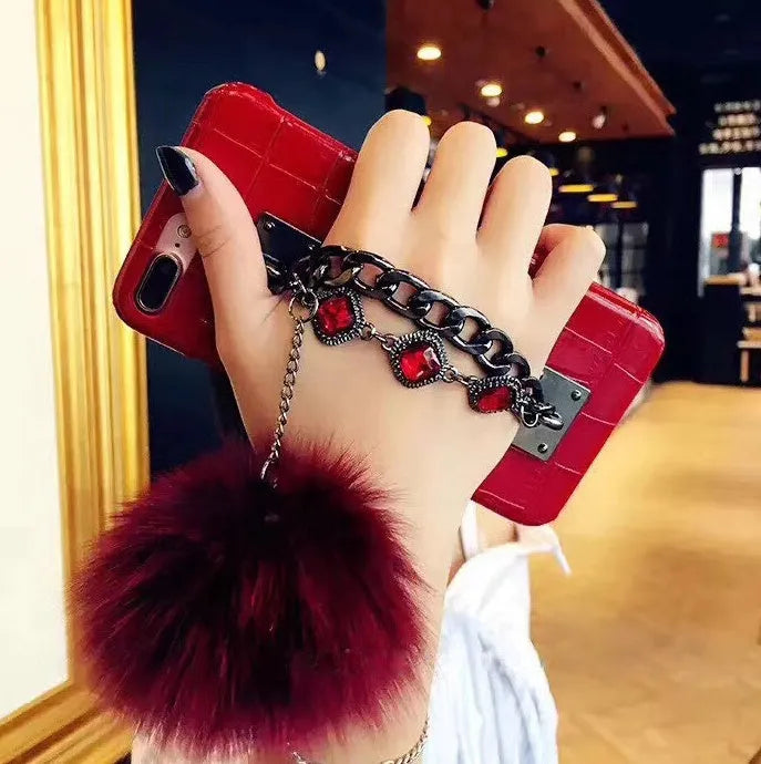 PU leather iPhone case with fox fur ball and rhinestone studs, compatible with iPhone 6, 6s, 7, 8, Plus, and X.