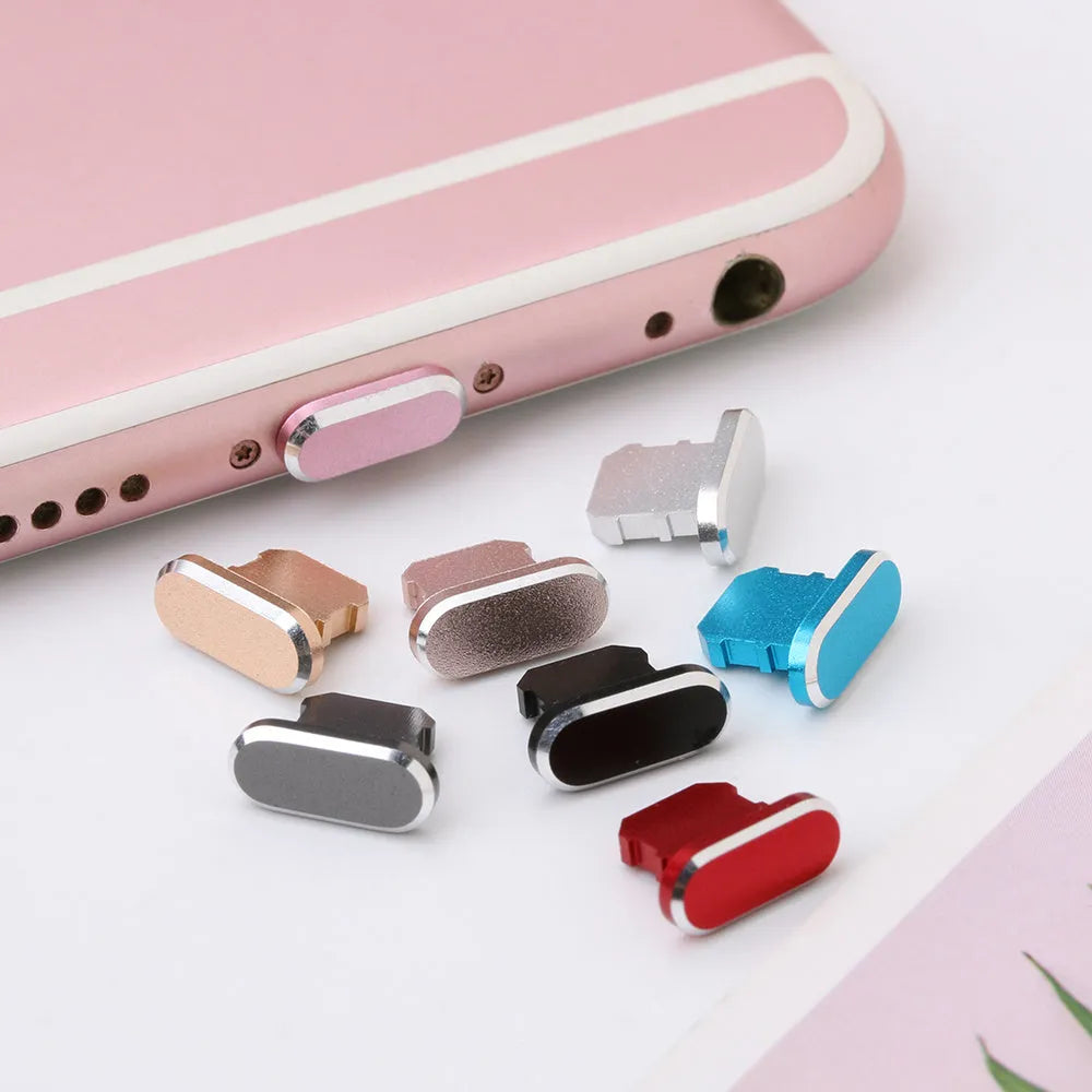 Aluminium alloy iPhone charging port dust plug in various colours including gold, silver, blue, and rose gold.
