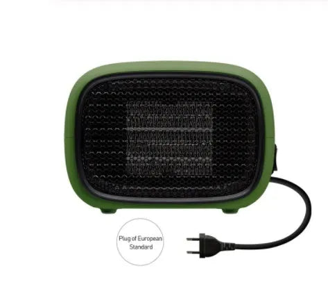 Green mini ceramic space heater with EU plug on a wooden desk