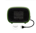 Green mini ceramic space heater with EU plug on a wooden desk