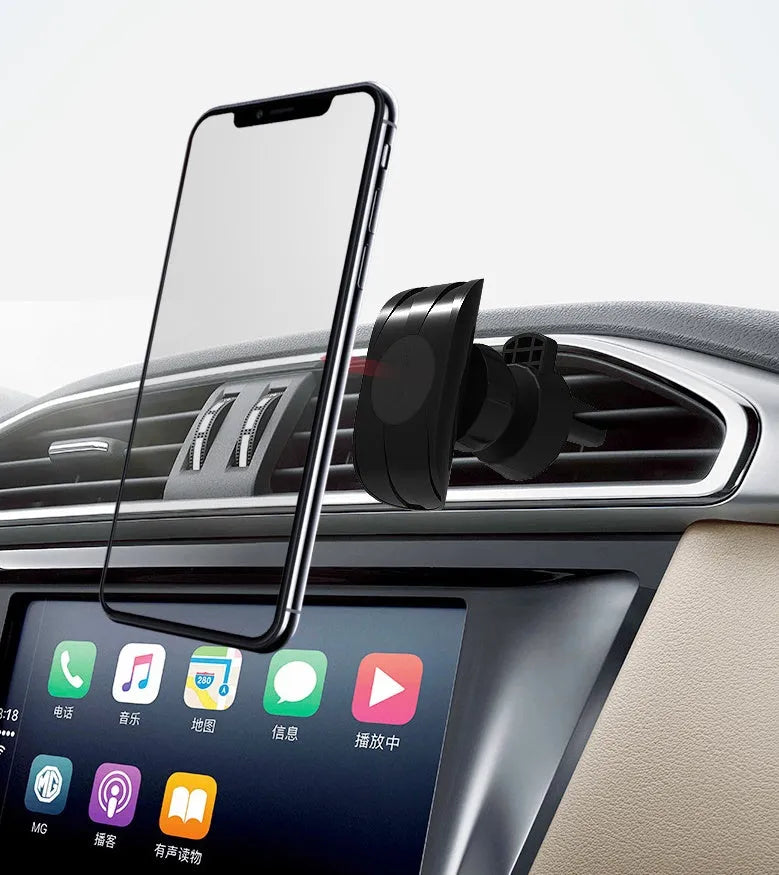 Black magnetic car phone holder mounted on car air vent with phone attached