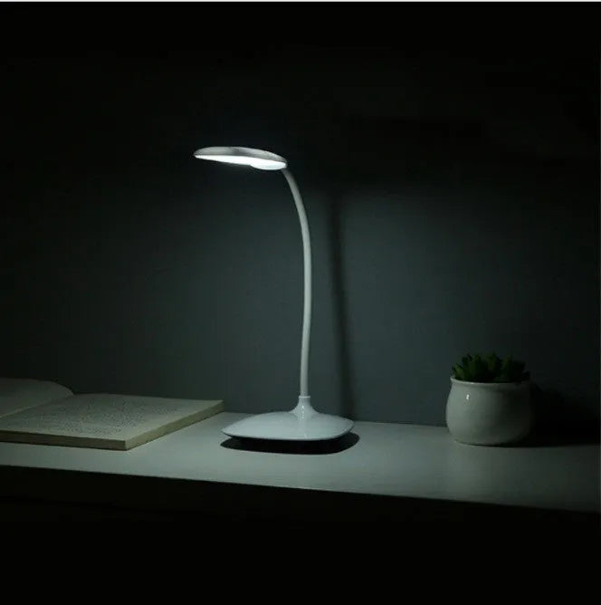 White LED desk lamp with USB charging cord and touch switch on a wooden desk