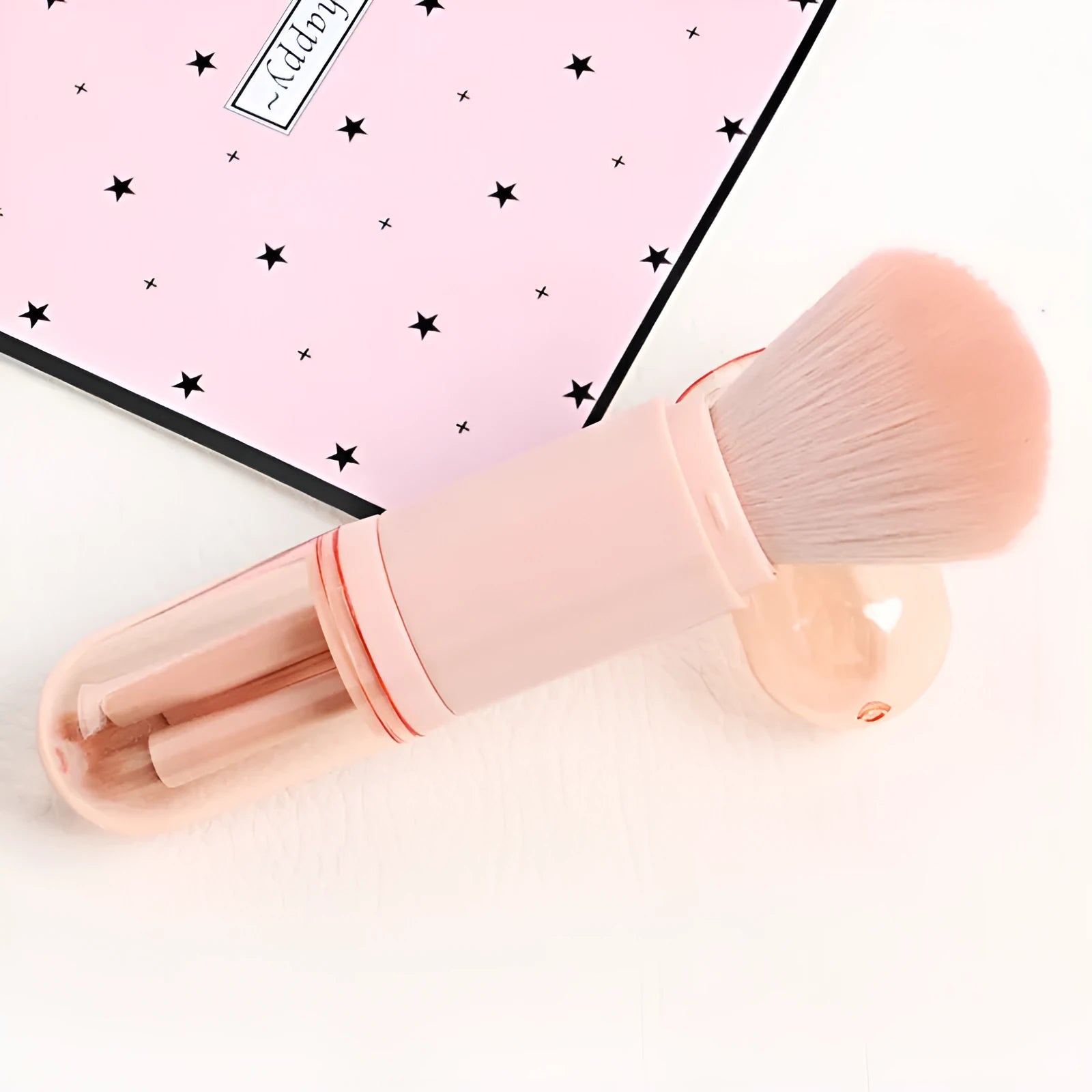 Single 4-in-1 retractable makeup brush set with four skin-colour bristle heads, 14cm total length, on a white background