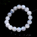 Natural blue moonlight round moonstone bead bracelet on a white background showing polished gemstone beads.
