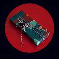 Green waterproof Christmas gift wrapping paper with Camellia design and black ribbon for gift boxes