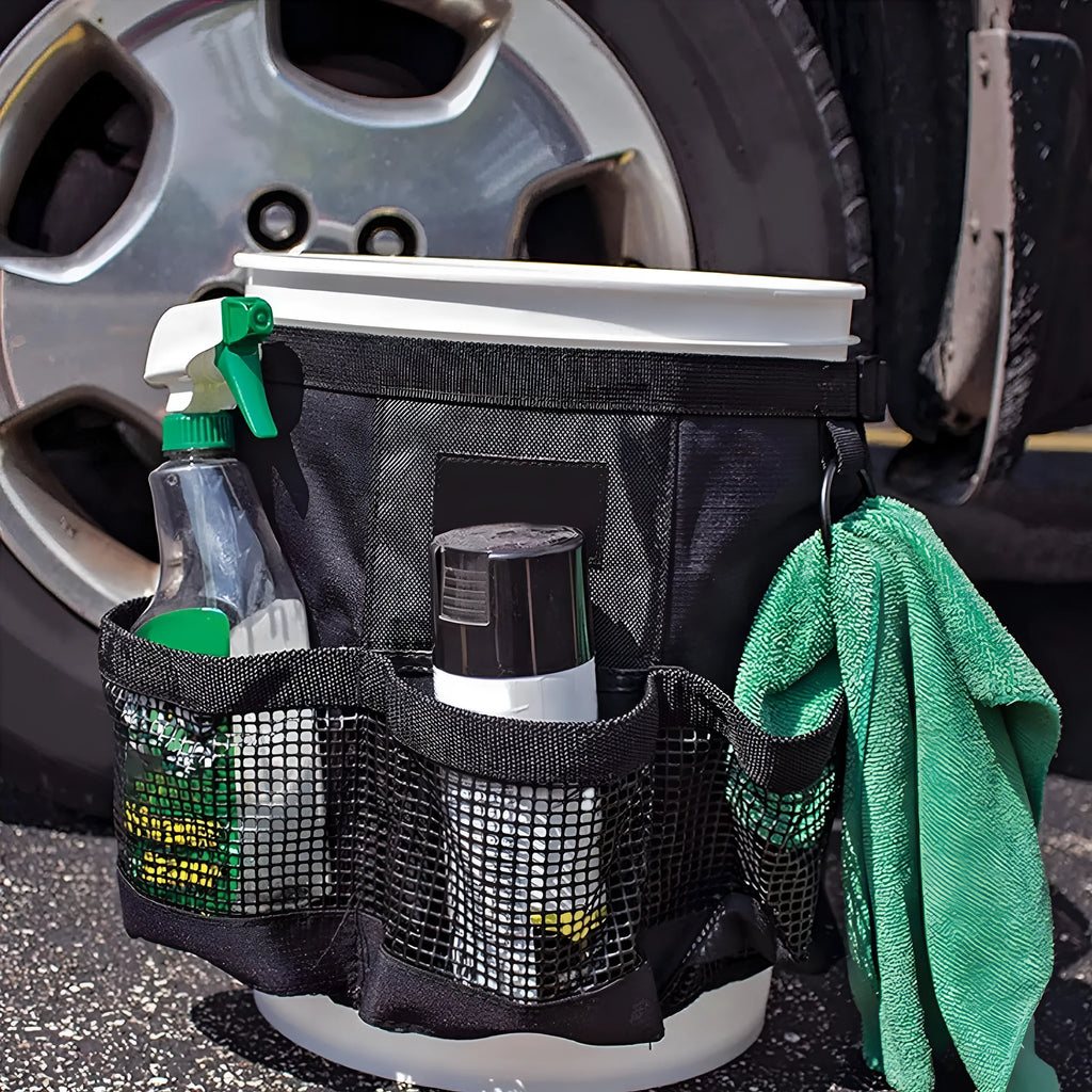 Black cylindrical buggy storage bag hanging from a 5 gallon barrel with car washing tools inside