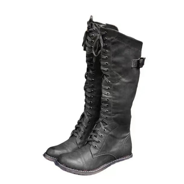 Women's black chunky heel high leg boot with a round toe and rubber sole.
