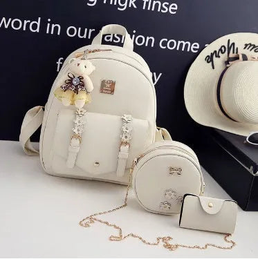 Women's 3-piece floral print PU leather bag set showing backpack, shoulder bag, and card purse in pink.