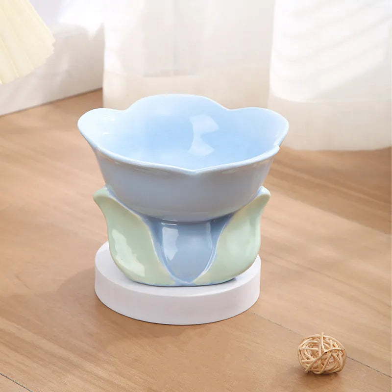 Blue ceramic elevated pet bowl with floral pattern and non-slip base for cat or small dog