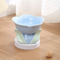 Blue ceramic elevated pet bowl with floral pattern and non-slip base for cat or small dog