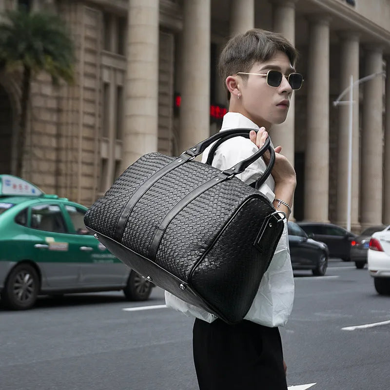 Black medium PU leather shoulder bag with woven texture and zipper closure for travel and business use
