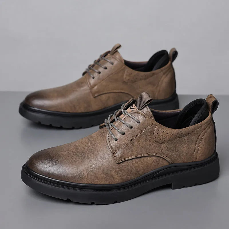 Men's black and brown leather casual sneakers with sewing line detail on the cowhide upper and a rubber sole.