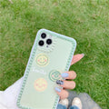 Green TPU iPhone case with geometric shapes and smiley faces inside a polka dot frame.
