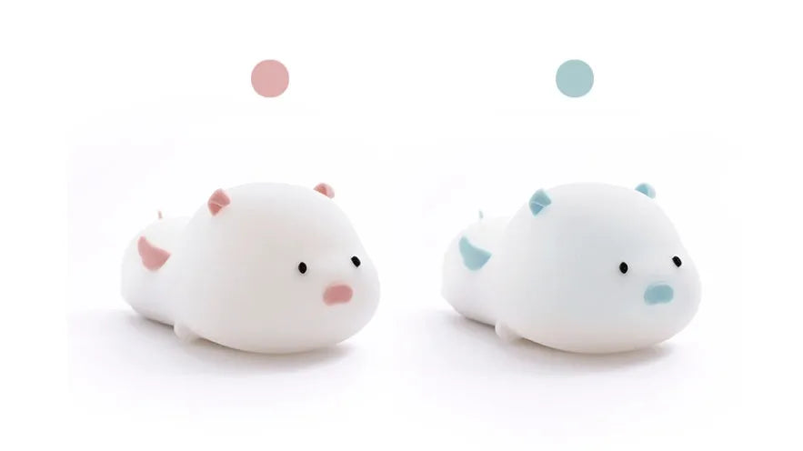 Pink silicone pig-shaped night light with touch control on bedside table