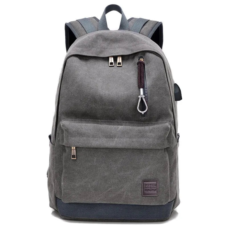 Canvas backpack with USB charging port showing computer compartment and multiple pockets