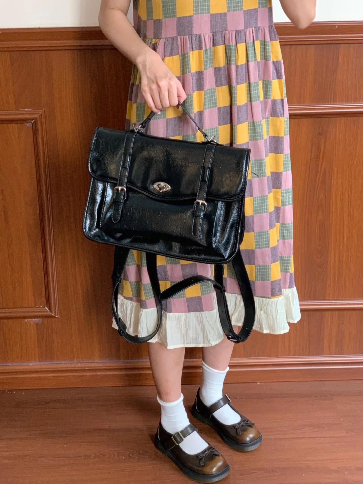 Black college style messenger bag with oil wax leather finish and 35cm length dimensions