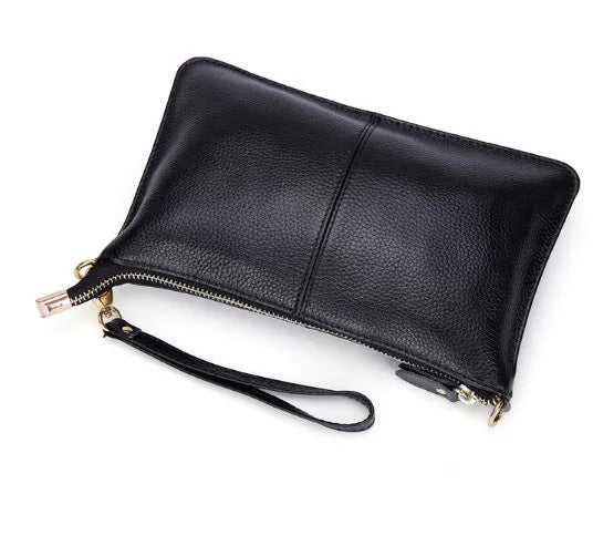 Lady cowhide slant bag showing hand strap and shoulder strap options with organised internal compartments