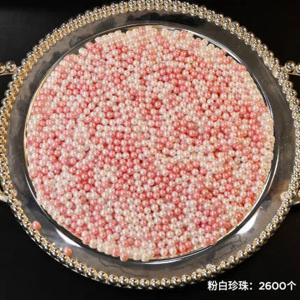 Clear acrylic makeup brush holder on a countertop with pearl coloured beads inside, measuring 12.3x10.6x21.5cm